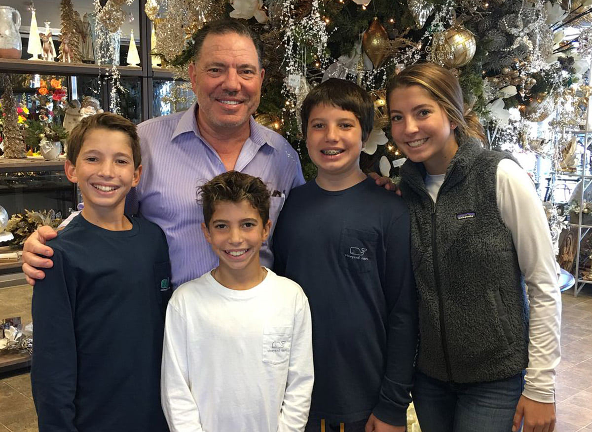 Mark Silacci, posing with family in the shop